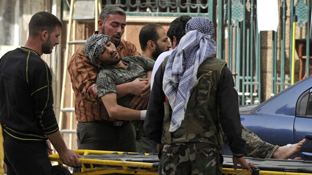 Syrians lift a wounded rebel fighter to take him into a hospital in Aleppo, Syria, in October. Doctors have few supplies to treat wounded fighters in Syria.