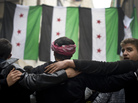 Rebel fighters take part in a demonstration against the Syrian regime after Friday prayers in Aleppo on Friday. Rebel fighters take part in a demonstration against the Syrian regime after Friday prayers in Aleppo on Friday.
