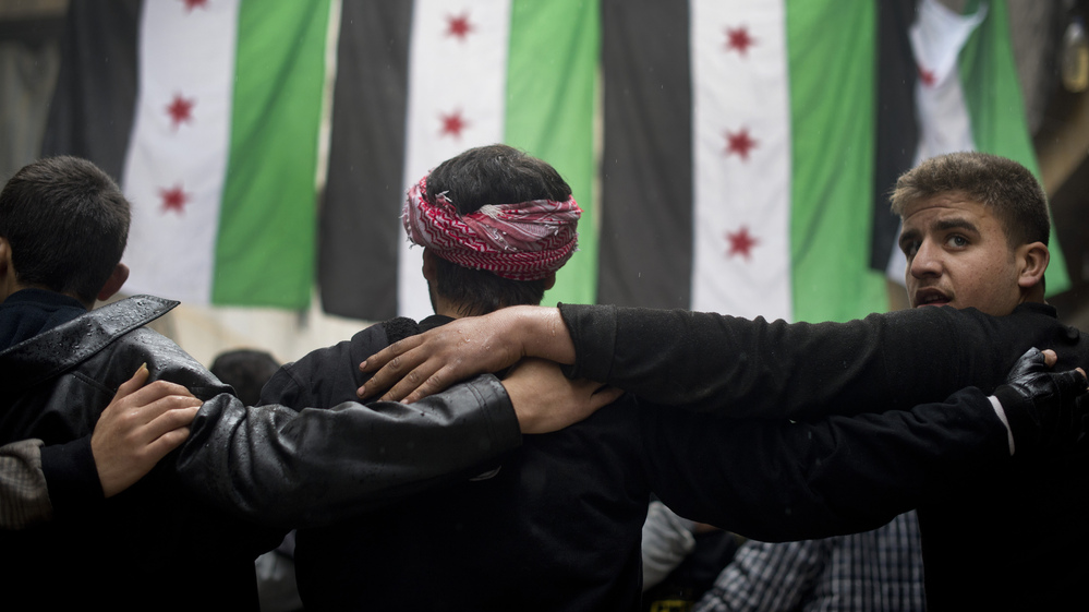 Rebel fighters take part in a demonstration against the Syrian regime after Friday prayers in Aleppo on Friday.
