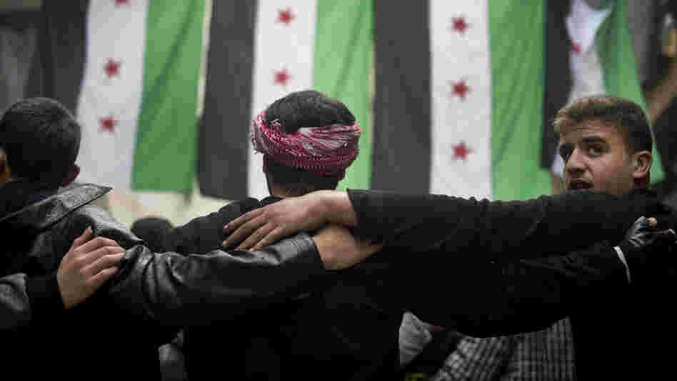 Rebel fighters take part in a demonstration against the Syrian regime after Friday prayers in Aleppo on Friday.