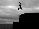 A boy jumps into the sea from high above in the harbor of Mousehole, Cornwall, England. A boy jumps into the sea from high above in the harbor of Mousehole, Cornwall, England.