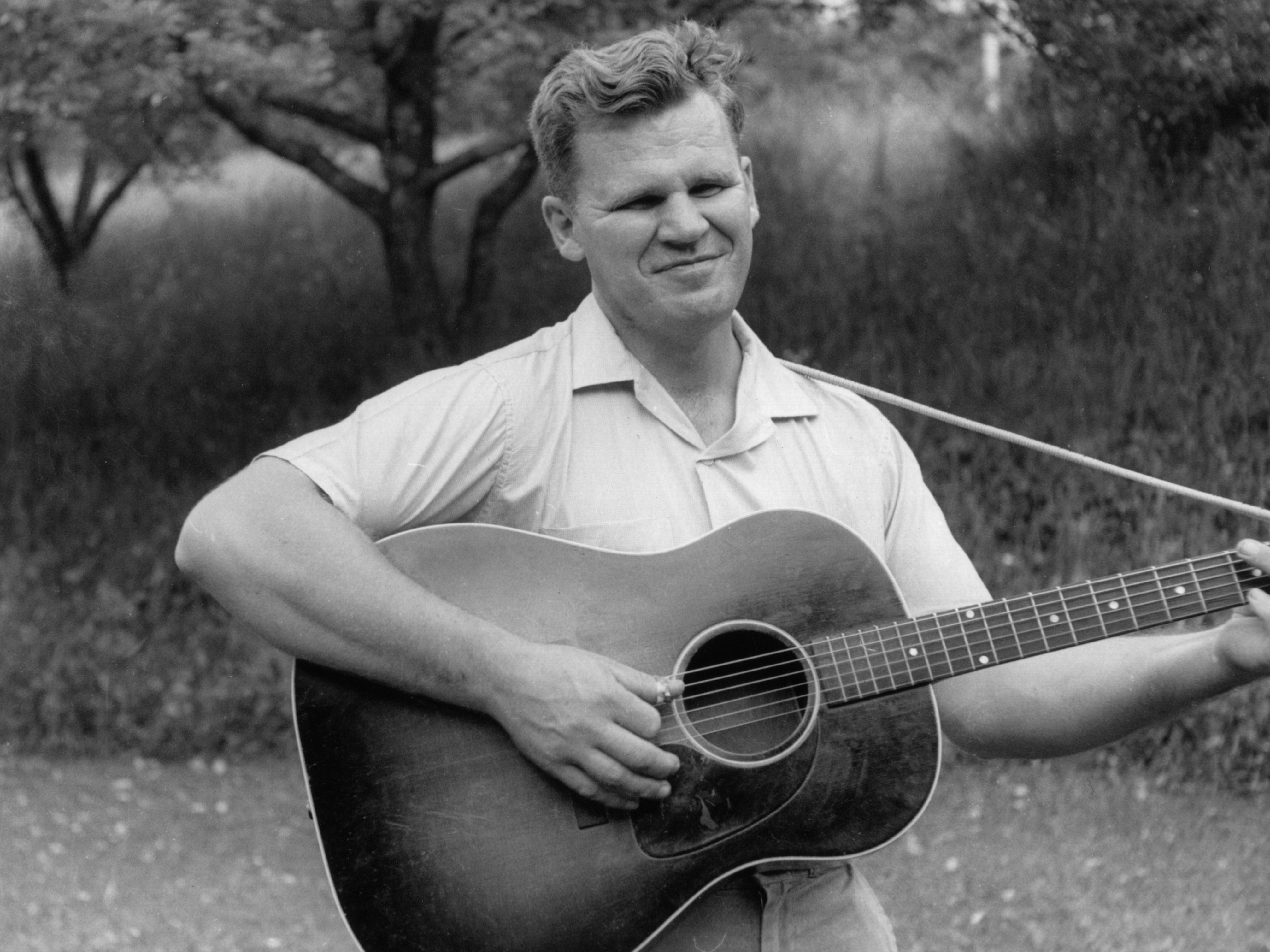 American blues, folk, and country musician Doc Watson (born Arthel Lane Watson) plays the guitar, 1960s.