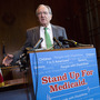 Sen. Tom Harkin, D-Iowa, speaks Tuesday as Rep. Elijah Cummings, D-Md., Sen. Sheldon Whitehouse, D-R.I., Sen. Al Franken, D-Minn., and Sen. Ben Cardin, D-Md., listen during a news conference on Capitol Hill calling for no reduction in the Medicare and Medicaid budgets as part of the year-end budget talks.