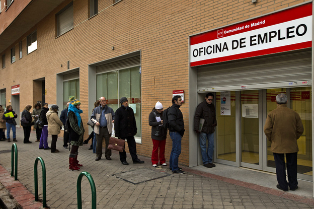 People queue up at a government job center in Madrid this month. The unemployment rate in Spain now tops 25 percent, but many government workers still enjoy job security and higher wages than their private sector counterparts.