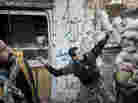 To date, Syrian rebels have had to rely on small-scale weapons in their fight against the Syrian army. Here, a rebel fighter throws an explosive device toward a Syrian government position in the northern city of Aleppo last month.