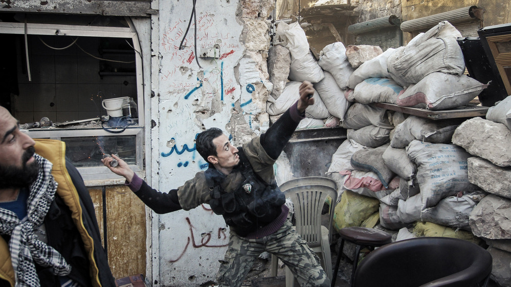 To date, Syrian rebels have had to rely on small-scale weapons in their fight against the Syrian army. Here, a rebel fighter throws an explosive device toward a Syrian government position in the northern city of Aleppo last month.