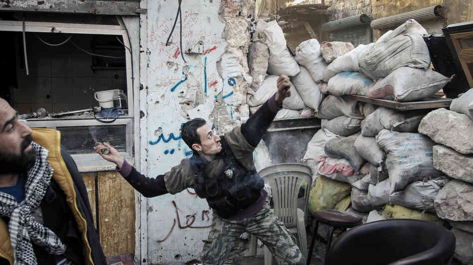 To date, Syrian rebels have had to rely on small-scale weapons in their fight against the Syrian army. Here, a rebel fighter throws an explosive device toward a Syrian government position in the northern city of Aleppo last month.