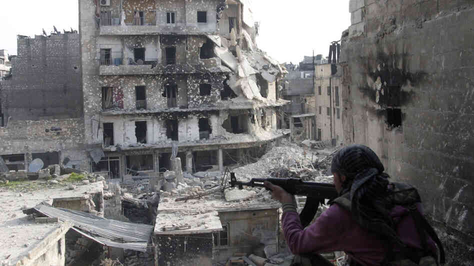 The Syrian military fired Scud missiles on rebel positions in northern Syria this week, a Pentagon source says. Here, a rebel fighter takes a position last month in the northern city of Aleppo, the scene of heavy fighting in recent months.