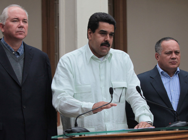 Venezuelan Vice President Nicolas Maduro, center, addresses the nation flanked by Oil Minister Rafael Ramirez, left, and National Assembly President Diosdado Cabello at the Miraflores presidential palace in Caracas, Venezuela, on Wednesday.