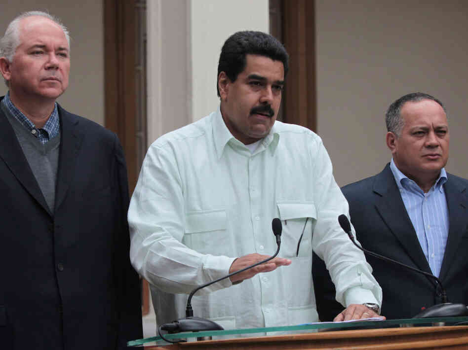 Venezuelan Vice President Nicolas Maduro, center, addresses the nation flanked by Oil Minister Rafael Ramirez, left, and National Assembly President Diosdado Cabello at the Miraflores presidential palace in Caracas, Venezuela, on Wednesday.