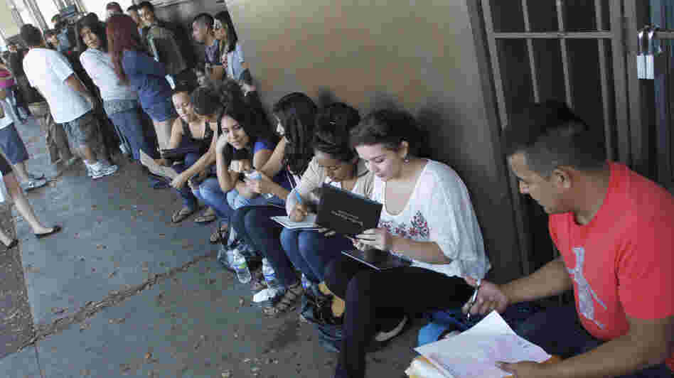 A crowd seeks help applying for the Deferred Action for Childhood Arrivals program at the Coalition for Humane Immigrant Rights of Los Angeles in August. Schools have been inundated with requests for the documents needed to qualify.