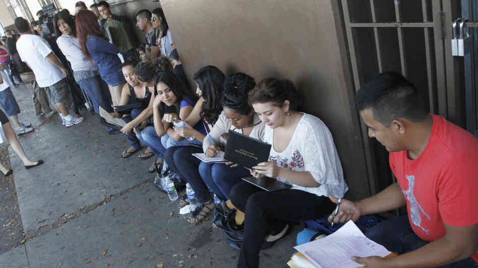 A crowd seeks help applying for the Deferred Action for Childhood Arrivals program at the Coalition for Humane Immigrant Rights of Los Angeles in August. Schools have been inundated with requests for the documents needed to qualify.