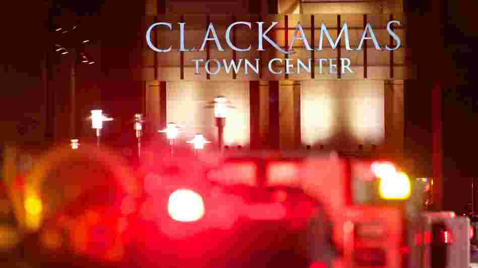 The lights of emergency vehicles illuminated the night Tuesday at the Clackamas Town Center mall just outside Portland.