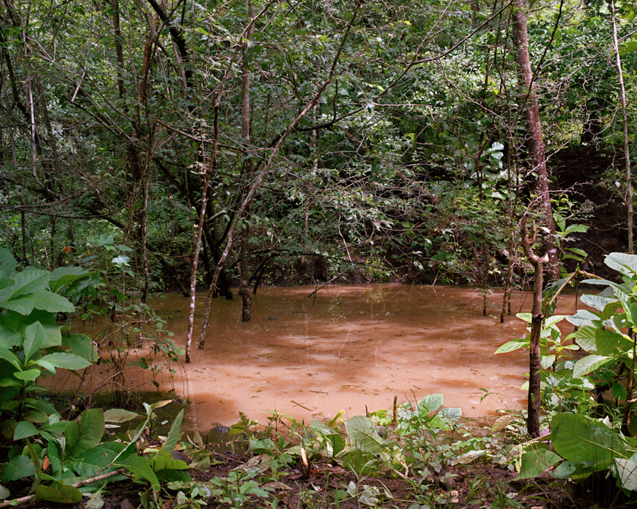 A bomb crater that remains from the civil war fills with water during the rainy season.