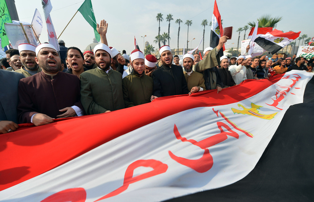 Egyptian clerics from Al-Azhar University hold a national flag as they shout support for President Mohammed Morsi and a new constitution at a rally in Cairo on Dec. 1. Secular and Islamist Egyptians disagree on the constitution, which critics say gives too much power to the clerics of Al-Azhar, the seat of Sunni Islam learning.