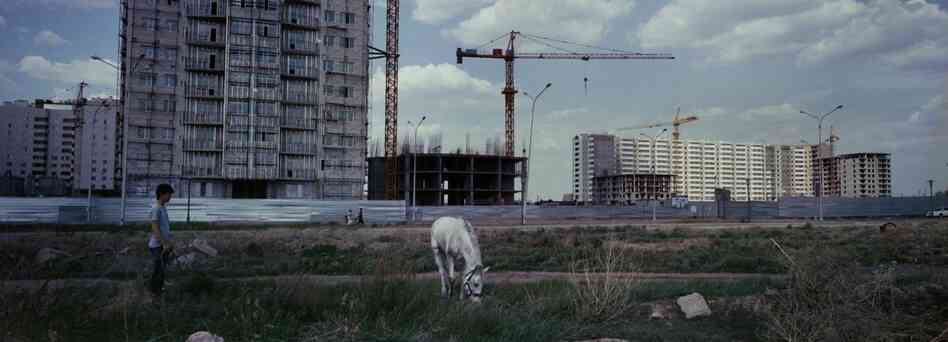 Horses graze near a construction site in Astana, Kazakhstan, 2012. Astana is a growing new capital in oil-rich Kazakhstan. Kazakhstan's President Nursultan Nazarbayev moved the capital from Almaty to Astana in 1997.