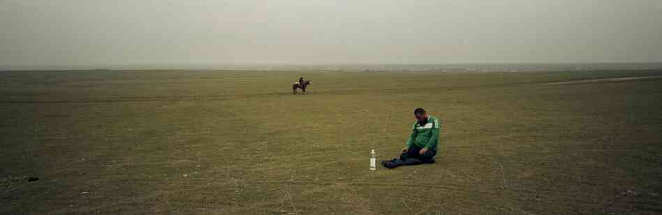 A Kazakh man prays in the steppe near Shymkent in southern Kazakhstan, 2012. The Islamic population has been increasing around Central Asia.