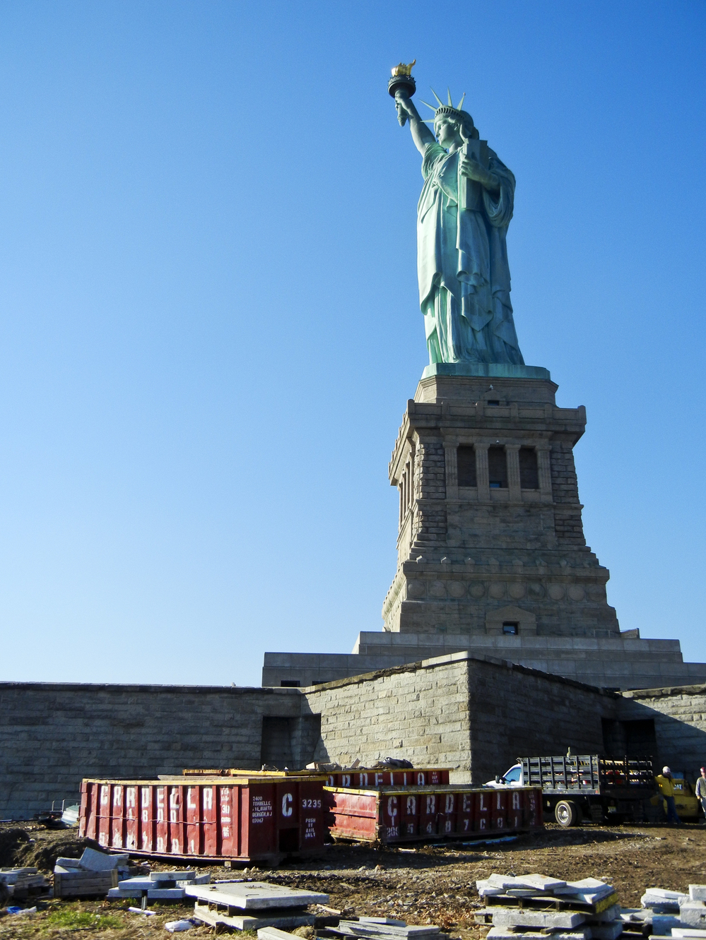 The Statue of Liberty survived Sandy unscathed, but Liberty Island remains closed indefinitely as workers remove mud and debris.