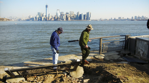 Interior Secretary Ken Salazar (left) and Statue of Liberty National Monument Superintendent David Luchsinger tour flood damage on Liberty Island on Thursday.