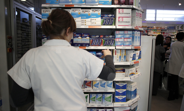 An employee tidies boxes of medicines displayed in a pharmacy in the city of Caen in western France last month. Beginning in 2013, girls between the ages of 15 and 18 will be able to get birth control free of charge, and without parental notification.
