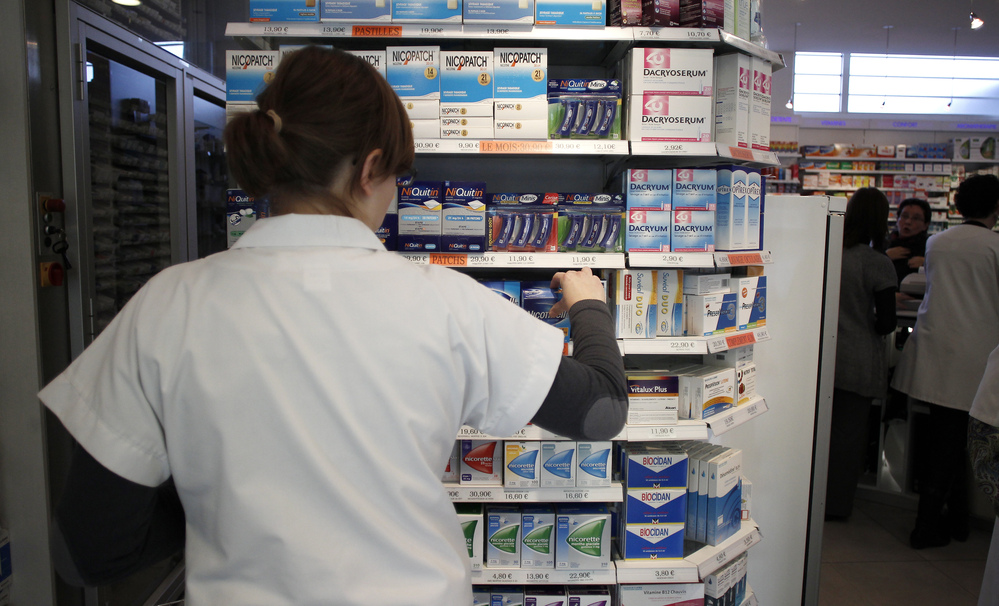 An employee tidies boxes of medicines displayed in a pharmacy in the city of Caen in western France last month. Beginning in 2013, girls between the ages of 15 and 18 will be able to get birth control free of charge, and without parental notification.