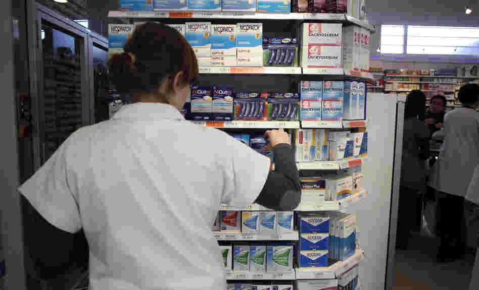 An employee tidies boxes of medicines displayed in a pharmacy in the city of Caen in western France last month. Beginning in 2013, girls between the ages of 15 and 18 will be able to get birth control free of charge, and without parental notification.