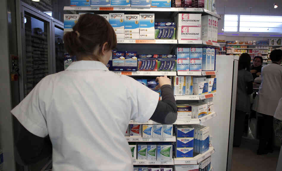 An employee tidies boxes of medicines displayed in a pharmacy in the city of Caen in western France last month. Beginning in 2013, girls between the ages of 15 and 18 will be able to get birth control free of charge, and without parental notification.