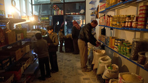 Customers shop by candlelight in a grocery store in Aleppo. The city has been hit hard by fighting in recent months, with both the opposition and the government controlling parts of the area.