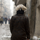 A Syrian woman carries a ration of bread on her head in the northern city of Aleppo. The Syrian opposition now runs local councils in many cities, particularly in the north. They often face major challenges in providing basics likes food, water and electricity.