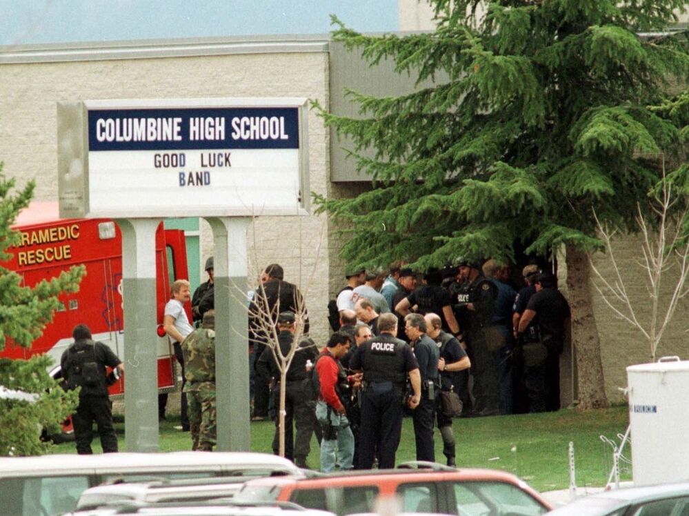 Police gather at the east entrance of Columbine High School in Littleton, Colo., on April 20, 1999. School security has improved markedly since the Columbine shooting, experts say, but there still are problems.