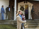 A woman holds a child as people line up to enter the Newtown Methodist Church near the scene of the elementary school shootings in Newtown, Conn. A woman holds a child as people line up to enter the Newtown Methodist Church near the scene of the elementary school shootings in Newtown, Conn.
