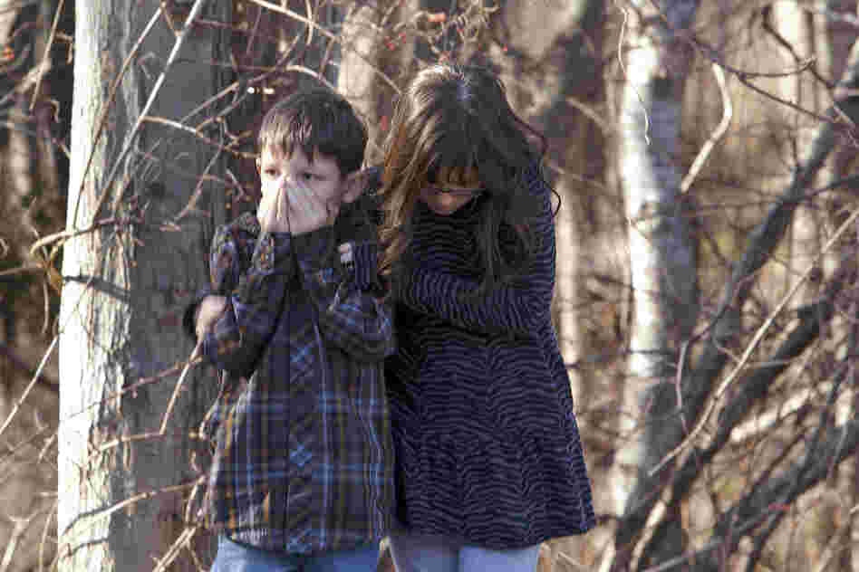 Young children wait outside the elementary school.