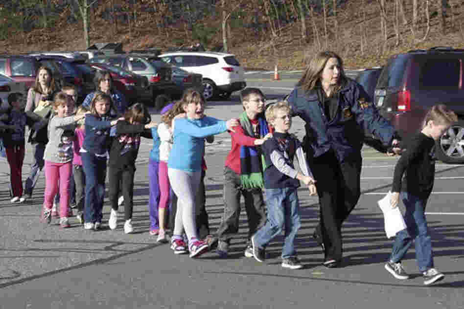 Connecticut State Police lead children from Sandy Hook Elementary.