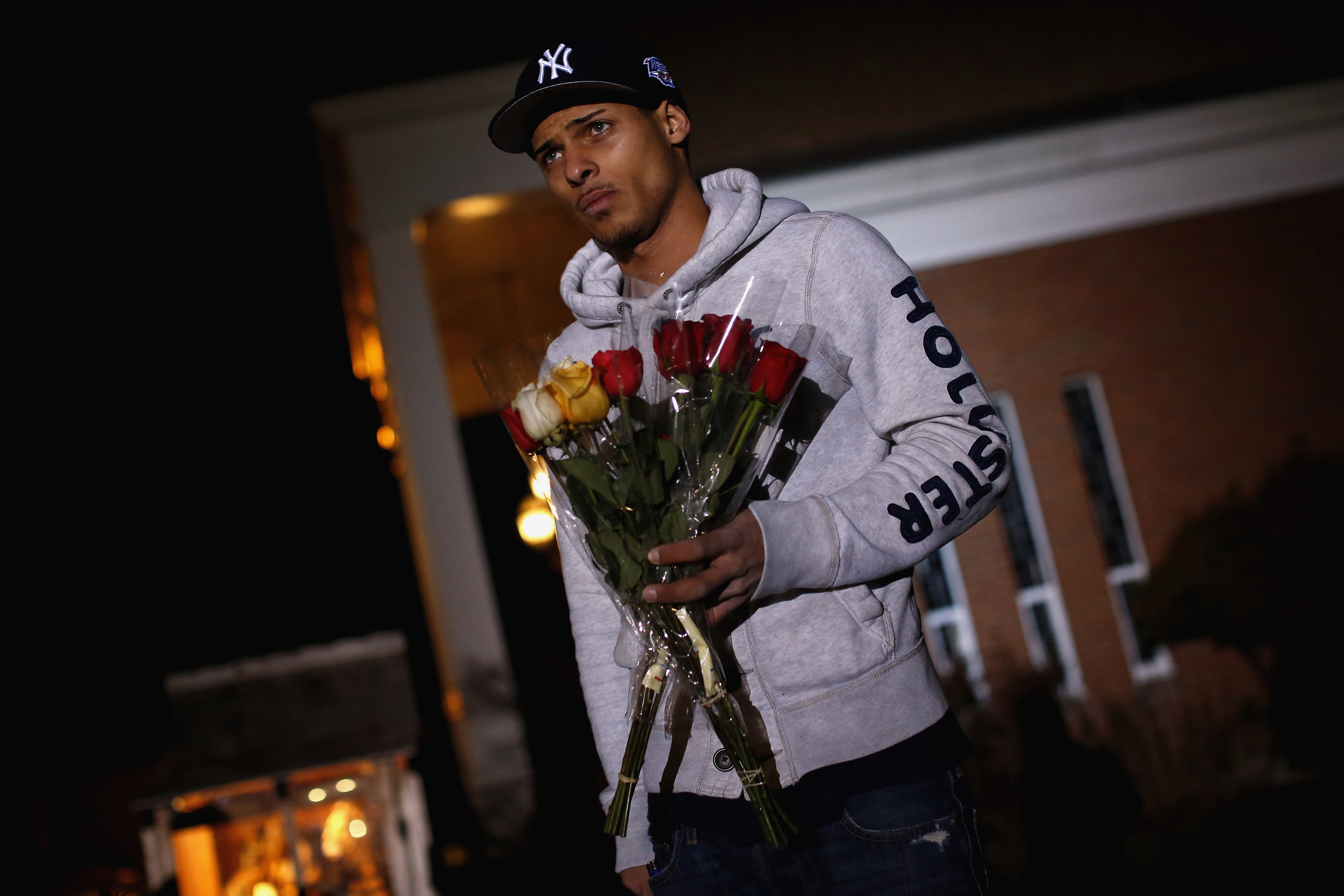 Anthony Baracey holds flowers honoring victims of the Sandy Hook Elementary school killing before a vigil at the Saint Rose of Lima church in Newtown. Anthony Baracey holds flowers honoring victims of the Sandy Hook Elementary school killing before a vigil at the Saint Rose of Lima church in Newtown.