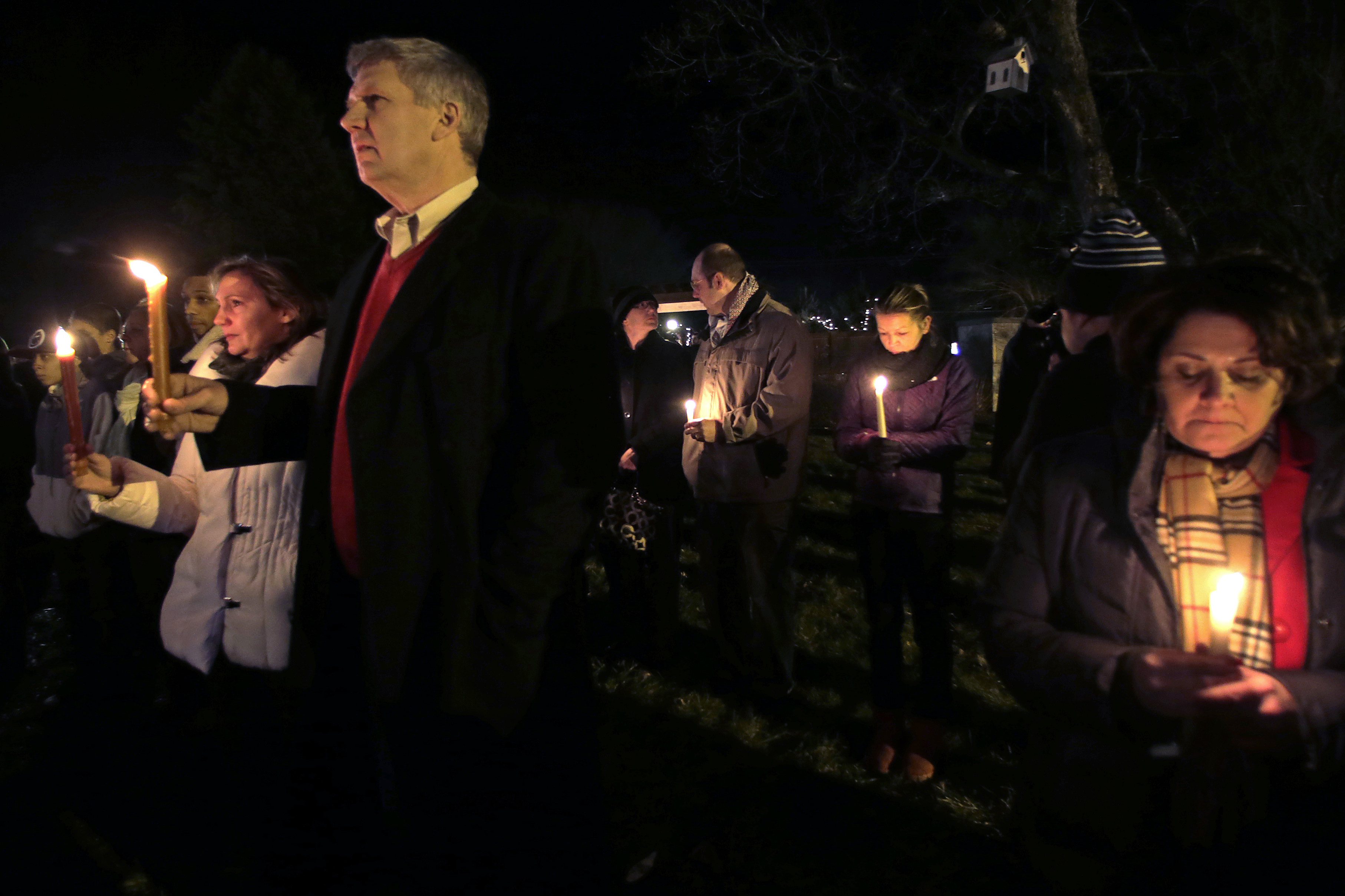 Men and women hold candles in vigil outside St. Rose of Lima Roman Catholic Church during a healing service held in for victims of the shooting at Sandy Hook Elementary School in Newtown, Conn., on Friday. Men and women hold candles in vigil outside St. Rose of Lima Roman Catholic Church during a healing service held in for victims of the shooting at Sandy Hook Elementary School in Newtown, Conn., on Friday.