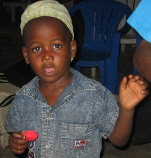 A Nigerian boy receives a dreidel for Hanukkah.