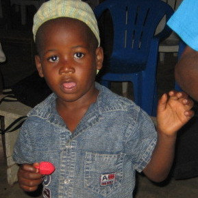 A Nigerian boy receives a dreidel for Hanukkah.