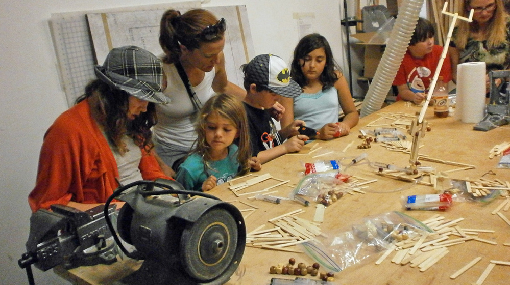 Kids build robots with Popsicle sticks at an Oakland meeting of Hacker Scouts, a group that encourages young people to create do-it-yourself crafts and electronics.