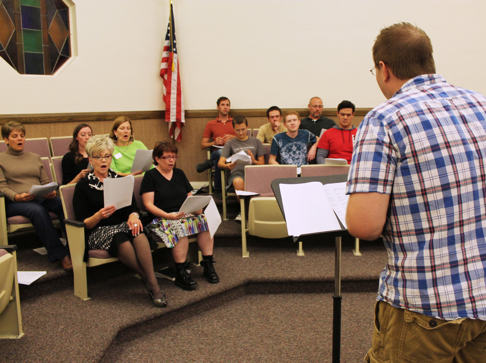 The choir's musical director, Bryan Horn, leads the ensemble in rehearsal.