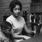 Myrlie Evers-Williams leads her three children — Reena (from left), Van and Darrell — at the family piano, circa 1965. Myrlie Evers-Williams leads her three children — Reena (from left), Van and Darrell — at the family piano, circa 1965.