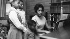 Myrlie Evers-Williams leads her three children — Reena (from left), Van and Darrell — at the family piano, circa 1965. Myrlie Evers-Williams leads her three children — Reena (from left), Van and Darrell — at the family piano, circa 1965.