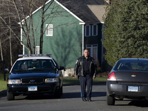 Police block a road near the house of Nancy Lanza in Newtown, Conn., on Saturday. Authorities say Lanza's son Adam killed her before opening fire at Sandy Hook Elementary School on Friday.