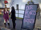 Shop owners Tamara Doherty (left) and Jackie Gaudet meet outside their stores for the first time since becoming neighbors, just down the road from Sandy Hook Elementary School in Newtown, Conn.