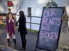 Shop owners Tamara Doherty (left) and Jackie Gaudet meet outside their stores for the first time since becoming neighbors, just down the road from Sandy Hook Elementary School in Newtown, Conn. Shop owners Tamara Doherty (left) and Jackie Gaudet meet outside their stores for the first time since becoming neighbors, just down the road from Sandy Hook Elementary School in Newtown, Conn.