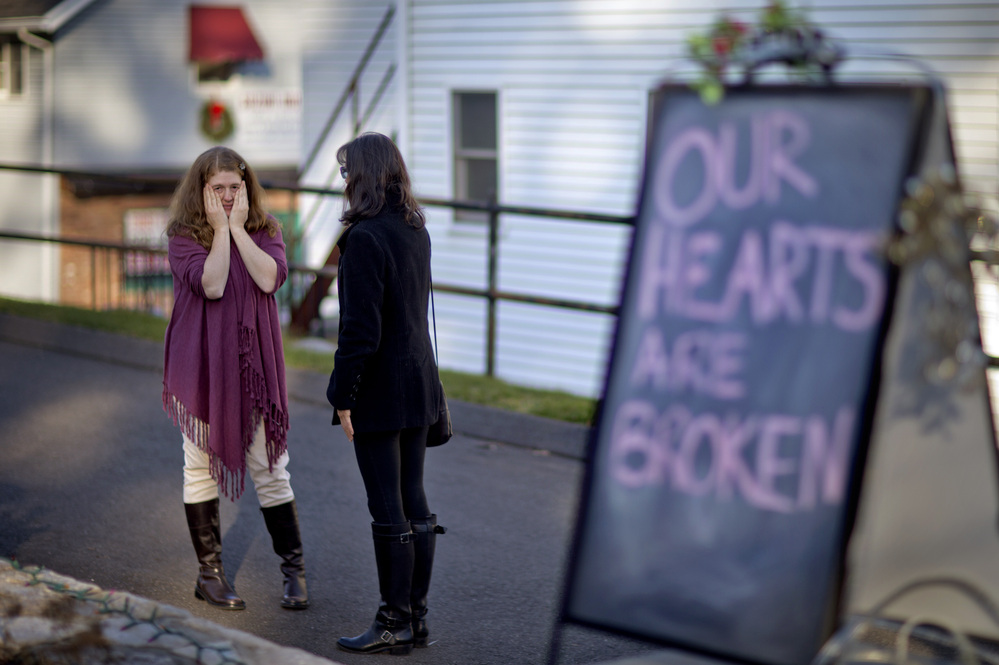 Shop owners Tamara Doherty, left, and Jackie Gaudet, right, meet outside their stores for the first time since being neighbors, just down the road from Sandy Hook Elementary School in Newtown, Conn. Shop owners Tamara Doherty, left, and Jackie Gaudet, right, meet outside their stores for the first time since being neighbors, just down the road from Sandy Hook Elementary School in Newtown, Conn.