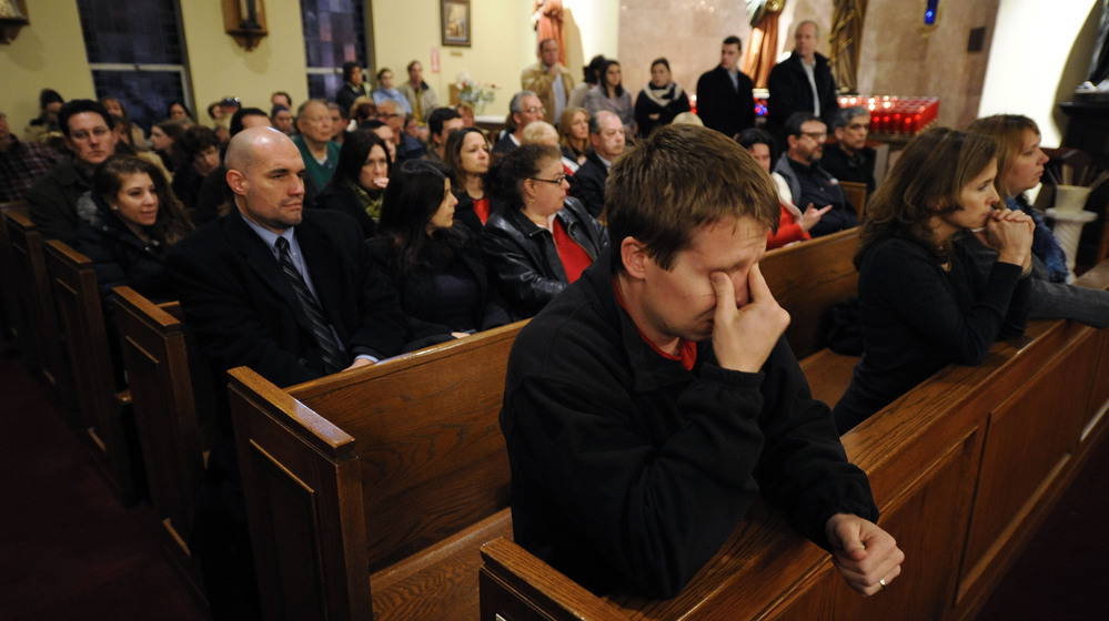 Mourners gather for a vigil service for victims of the Sandy Hook Elementary School shooting, at the St. Rose of Lima Roman Catholic Church in Newtown, Conn. on Friday night. Mourners gather for a vigil service for victims of the Sandy Hook Elementary School shooting, at the St. Rose of Lima Roman Catholic Church in Newtown, Conn. on Friday night.