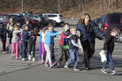 In a photograph taken by Shannon Hicks, police and teachers lead children away from Sandy Hook Elementary on Friday, Dec. 14. In a photograph taken by Shannon Hicks, police and teachers lead children away from Sandy Hook Elementary on Friday, Dec. 14.