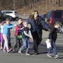 In a photograph taken by Shannon Hicks, police and teachers lead children away from Sandy Hook Elementary on Friday, Dec. 14. In a photograph taken by Shannon Hicks, police and teachers lead children away from Sandy Hook Elementary on Friday, Dec. 14.