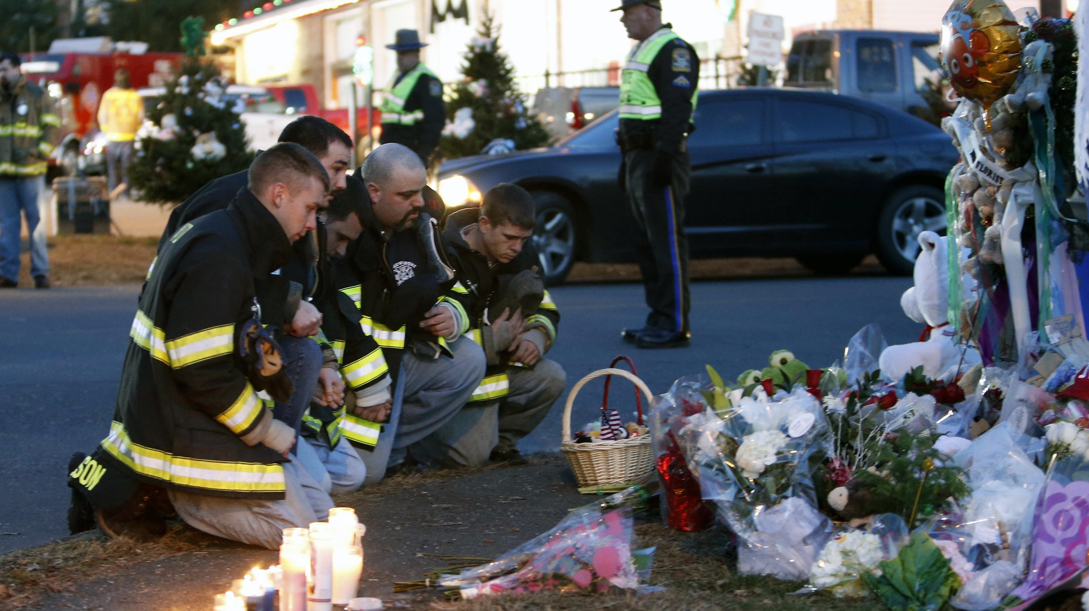 Firefighters pay their respects at a memorial for shooting victims near Sandy Hook Elementary School on Saturday. Firefighters pay their respects at a memorial for shooting victims near Sandy Hook Elementary School on Saturday.