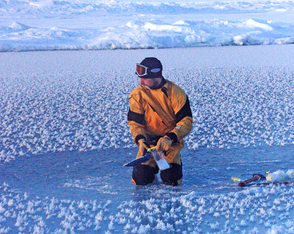 Jeff Bowman collects samples from frost flowers in the central Arctic Ocean.